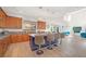 Open concept kitchen with an island and seating, looking into living room at 8 Hilltop Crest St, Henderson, NV 89011