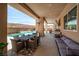 Inviting outdoor patio featuring a dining set, stylish seating, and a beautiful pool with scenic views at 8 Hilltop Crest St, Henderson, NV 89011