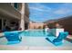 Stunning pool area with lounge chairs, fire bowls, and beautiful views of the surrounding landscape at 8 Hilltop Crest St, Henderson, NV 89011