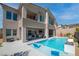 Luxury backyard with a sparkling pool, comfortable lounge chairs, and an outdoor kitchen area at 8 Hilltop Crest St, Henderson, NV 89011
