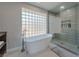 Spa-like bathroom with soaking tub and walk-in shower at 8120 Castle Pines Ave, Las Vegas, NV 89113