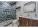 Clean bathroom with gray tiled shower and modern vanity at 8120 Castle Pines Ave, Las Vegas, NV 89113