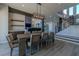 Elegant dining room featuring a large wooden table and modern chandelier at 8120 Castle Pines Ave, Las Vegas, NV 89113