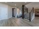 Bright entryway with modern staircase and wood-look flooring at 8120 Castle Pines Ave, Las Vegas, NV 89113