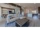 Spacious living room with a light-colored sectional sofa and modern coffee table at 8120 Castle Pines Ave, Las Vegas, NV 89113