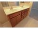 Double sink bathroom vanity with wood cabinets at 8353 Stillhouse Ct, Las Vegas, NV 89113