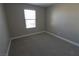 Spacious bedroom with carpeted floor and large window at 8353 Stillhouse Ct, Las Vegas, NV 89113