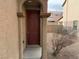 Home's entrance with a burgundy door and stone entryway at 8353 Stillhouse Ct, Las Vegas, NV 89113