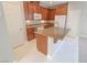 Kitchen with an island, granite countertops, and wood cabinets at 8353 Stillhouse Ct, Las Vegas, NV 89113