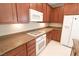 White appliances and wood cabinets in kitchen at 8353 Stillhouse Ct, Las Vegas, NV 89113