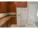 White refrigerator and wood cabinets in kitchen at 8353 Stillhouse Ct, Las Vegas, NV 89113