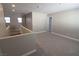 Spacious loft area with neutral carpeting and access to other rooms at 8353 Stillhouse Ct, Las Vegas, NV 89113