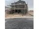 Two-story house under construction, gray stucco exterior, scaffolding visible at 8406 Sycamore Creek St, Las Vegas, NV 89113