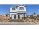 Two-story home with gray siding, stone accents, and landscaping at 8406 Sycamore Creek St, Las Vegas, NV 89113