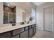 Elegant bathroom, featuring double sinks and a large mirror at 9016 Skye Canyon Ranch St, Las Vegas, NV 89166