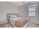 Cozy bedroom with a neutral color scheme and window at 9016 Skye Canyon Ranch St, Las Vegas, NV 89166