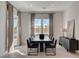 Bright dining room with large windows and dark wood table at 9016 Skye Canyon Ranch St, Las Vegas, NV 89166