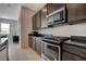 Modern kitchen with stainless steel appliances and dark wood cabinets at 9016 Skye Canyon Ranch St, Las Vegas, NV 89166