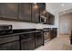 Modern kitchen with stainless steel appliances and dark wood cabinets at 9016 Skye Canyon Ranch St, Las Vegas, NV 89166