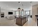 Modern kitchen with dark wood cabinets and a large island at 9016 Skye Canyon Ranch St, Las Vegas, NV 89166