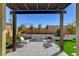 Relaxing patio with pergola, seating and grassy area at 9016 Skye Canyon Ranch St, Las Vegas, NV 89166