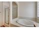 Bathroom with a shower and a large soaking tub at 9092 National Park Dr, Las Vegas, NV 89178