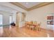 Open dining area with hardwood floors and a view into the kitchen at 9092 National Park Dr, Las Vegas, NV 89178