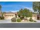 Single-story home with three-car garage, mature landscaping, and a spacious driveway at 9092 National Park Dr, Las Vegas, NV 89178