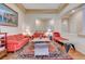 Open living room with hardwood floors, red couches and a view of entryway at 9092 National Park Dr, Las Vegas, NV 89178