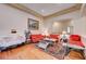 Spacious living room with hardwood floors, featuring comfortable red sofas and a coffee table at 9092 National Park Dr, Las Vegas, NV 89178