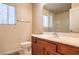 Powder room with single vanity, framed mirror, and a window with blinds at 9328 Freedom Heights Ave, Las Vegas, NV 89149