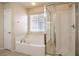 Bathroom features a soaking tub with tile surround and a separate glass enclosed shower at 9328 Freedom Heights Ave, Las Vegas, NV 89149