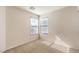 Bedroom with neutral walls, carpet flooring and two windows offering ample natural light at 9328 Freedom Heights Ave, Las Vegas, NV 89149