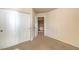 Bedroom with carpet flooring, a double door closet, and an open doorway to the hallway at 9328 Freedom Heights Ave, Las Vegas, NV 89149