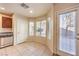 Bright dining area with tile flooring, stainless steel appliances, and a door to the backyard at 9328 Freedom Heights Ave, Las Vegas, NV 89149