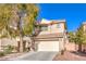 Two-story home featuring a two-car garage, desert landscaping, and a well-maintained front yard at 9328 Freedom Heights Ave, Las Vegas, NV 89149