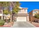 Two story house featuring a two car garage, landscaping, and a red tiled roof at 9328 Freedom Heights Ave, Las Vegas, NV 89149