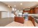 View of the kitchen and living room, showcasing tile floors and stainless steel appliances at 9328 Freedom Heights Ave, Las Vegas, NV 89149