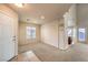 Open-concept living area with tile entry, carpet, and a view of the adjacent dining area and kitchen at 9328 Freedom Heights Ave, Las Vegas, NV 89149