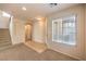 Inviting living room with carpet, tile entry, and stairs to the upper level, with a view to another room at 9328 Freedom Heights Ave, Las Vegas, NV 89149