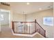 Upstairs loft area with railing and carpet at 9328 Freedom Heights Ave, Las Vegas, NV 89149