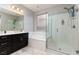 Bathroom with double vanity, soaking tub and walk-in shower at 1015 Solana Crest St, Henderson, NV 89052