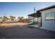 Backyard view showing a covered patio and a mostly dirt yard at 107 Manganese St, Henderson, NV 89015