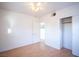 Spacious bedroom with wood floors, ceiling fan, and access to hallway at 107 Manganese St, Henderson, NV 89015