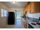Galley kitchen with black appliances and back door at 107 Manganese St, Henderson, NV 89015