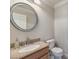 Neutral bathroom with granite vanity top, round mirror, and standard toilet, ideal for a simple space at 1104 Bower Basin St, Las Vegas, NV 89144