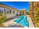 Beautiful outdoor pool area with a small pool, landscaping, and lounge chairs at 1104 Bower Basin St, Las Vegas, NV 89144