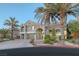 Two-story house with a landscaped yard and palm trees in the front at 11158 Antonine Wall Ct, Las Vegas, NV 89141