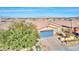 Single-story house with blue garage door, landscaping, and mountain views at 1290 El Solindo Ln, Henderson, NV 89002