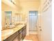 Bathroom with double sinks, granite countertop, and shower at 1290 El Solindo Ln, Henderson, NV 89002